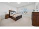 Cozy bedroom featuring a dark-wood dresser and carpet at 7560 Wild Violet Dr, Cumming, GA 30040
