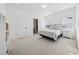 Light-filled bedroom with plush carpeting, en-suite bathroom, and ample closet space at 7560 Wild Violet Dr, Cumming, GA 30040