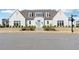 Beautiful white home featuring a light-blue front door, well-maintained landscaping, and a welcoming entryway at 7560 Wild Violet Dr, Cumming, GA 30040