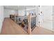 Upstairs hallway overlooking a large living room, with hardwood floors at 7560 Wild Violet Dr, Cumming, GA 30040