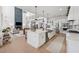 Modern kitchen with island seamlessly connects to a living room with a fireplace at 7560 Wild Violet Dr, Cumming, GA 30040