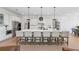 Bright kitchen with a large island with barstool seating and stainless steel appliances at 7560 Wild Violet Dr, Cumming, GA 30040