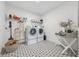 Bright laundry room with modern appliances, stylish black-and-white patterned floor, and ample storage space at 7560 Wild Violet Dr, Cumming, GA 30040