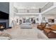 Open-concept living room with fireplace, comfortable seating, and staircase at 7560 Wild Violet Dr, Cumming, GA 30040