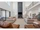 Bright living room with a soaring ceiling, fireplace, and modern furnishings at 7560 Wild Violet Dr, Cumming, GA 30040