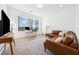 Bright and spacious living room with hardwood floors and neutral furniture at 7560 Wild Violet Dr, Cumming, GA 30040
