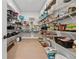 Well-stocked walk-in pantry with white wire shelving and wood floor at 7560 Wild Violet Dr, Cumming, GA 30040