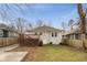 Spacious backyard with a wooden deck, lush lawn, mature trees, and a mix of sunny and shaded areas at 1613 Westwood Sw Ave, Atlanta, GA 30310