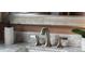 Close-up of a bathroom sink with modern faucet, marble countertop, and stylish soap dispenser at 1613 Westwood Sw Ave, Atlanta, GA 30310