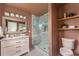 Modern bathroom with a glass-enclosed shower, marble tile, and stylish fixtures, creating a spa-like experience at 1613 Westwood Sw Ave, Atlanta, GA 30310