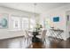 Bright dining room features a modern chandelier, neutral walls, and beautiful dark hardwood floors at 1613 Westwood Sw Ave, Atlanta, GA 30310