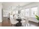 Bright dining area with modern chandelier, hardwood floors, and elegant seating at 1613 Westwood Sw Ave, Atlanta, GA 30310