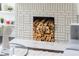 Close-up of a cozy fireplace with stacked firewood, adding warmth to the living space at 1613 Westwood Sw Ave, Atlanta, GA 30310