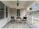 Cozy front porch with seating area, stylish rug, and hanging fern at 1613 Westwood Sw Ave, Atlanta, GA 30310