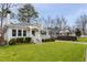 Quaint home featuring a lush green lawn and a welcoming entrance with a covered porch at 1613 Westwood Sw Ave, Atlanta, GA 30310