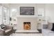 Detailed view of a brick fireplace with firewood, complemented by built-in shelves and modern accents at 1613 Westwood Sw Ave, Atlanta, GA 30310