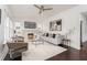 Bright living room featuring a decorative fireplace, modern furnishings, and hardwood floors at 1613 Westwood Sw Ave, Atlanta, GA 30310