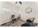 Bright home office featuring a ceiling fan, white trim, neutral walls, a modern desk, and a stylish accent chair at 1613 Westwood Sw Ave, Atlanta, GA 30310