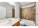 Bathroom featuring tub with tiled walls, toilet, vanity and a large mirror at 215 Aldridge Pl # 9, Smyrna, GA 30082