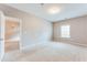 Spacious bedroom with neutral walls, carpet, and a window, adjoined by a doorway to another room at 215 Aldridge Pl # 9, Smyrna, GA 30082