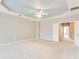 Spacious main bedroom featuring tray ceiling, neutral walls, and plush carpeting for a cozy, inviting atmosphere at 215 Aldridge Pl # 9, Smyrna, GA 30082