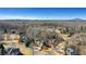 An aerial view showcases a neighborhood with well-maintained homes surrounded by a lush, wooded landscape at 3493 Maryhill Nw Ln, Kennesaw, GA 30152