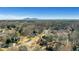 An aerial view of a beautiful neighborhood surrounded by lush greenery and distant mountain views at 3493 Maryhill Nw Ln, Kennesaw, GA 30152