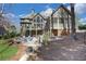 Rear view of a spacious house with a deck, lower patio with fire pit, and landscaped yard at 3493 Maryhill Nw Ln, Kennesaw, GA 30152