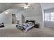 Spacious bedroom with sloped ceilings, a ceiling fan, and carpeted floors at 3493 Maryhill Nw Ln, Kennesaw, GA 30152