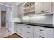 Charming butler's pantry with white cabinetry, black countertop, and views of a shower at 3493 Maryhill Nw Ln, Kennesaw, GA 30152