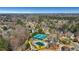 Aerial view featuring a community pool and tennis courts surrounded by a beautiful wooded area at 3493 Maryhill Nw Ln, Kennesaw, GA 30152