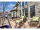 Inviting outdoor deck area with wicker furniture, dining set, and view of the wooded backyard at 3493 Maryhill Nw Ln, Kennesaw, GA 30152