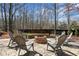 Brick patio featuring a cozy fire pit with chairs, creating a perfect outdoor gathering space at 3493 Maryhill Nw Ln, Kennesaw, GA 30152