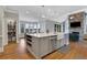 Open-concept kitchen island with stainless steel appliances, storage, and hardwood floors at 3493 Maryhill Nw Ln, Kennesaw, GA 30152