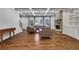 Spacious living room featuring hardwood floors, coffered ceiling, fireplace, and built-in shelving at 3493 Maryhill Nw Ln, Kennesaw, GA 30152