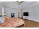 Spacious main bedroom featuring a tray ceiling, hardwood floors, and a colorful comforter at 3493 Maryhill Nw Ln, Kennesaw, GA 30152