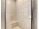 Tiled walk-in shower featuring a built-in bench seat at 3493 Maryhill Nw Ln, Kennesaw, GA 30152