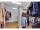 A well-organized walk-in closet with wood floor, shelving, and hanging rods at 3493 Maryhill Nw Ln, Kennesaw, GA 30152