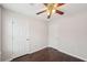 Bedroom with multiple closets, a ceiling fan and hard surface floors at 85 Windward Dr, Covington, GA 30016