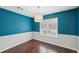 Dining room with hardwood floors and a modern light fixture at 85 Windward Dr, Covington, GA 30016