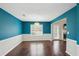 Dining area featuring hardwood floors, blue walls, and a modern pendant light at 85 Windward Dr, Covington, GA 30016