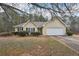 Charming home exterior with attached garage and manicured landscaping on a sunny day at 85 Windward Dr, Covington, GA 30016