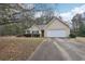 Traditional exterior of a one-story home featuring a driveway and attached two-car garage at 85 Windward Dr, Covington, GA 30016