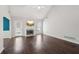 Bright living room featuring vaulted ceiling, a fireplace, and a door to the outside at 85 Windward Dr, Covington, GA 30016