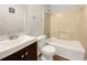 Clean bathroom with a shower-tub combo, modern vanity, and neutral-toned walls at 10632 Pine Forest Ne Ln, Jonesboro, GA 30238