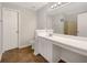 Bathroom featuring white vanity with an extended countertop and a large mirror at 10632 Pine Forest Ne Ln, Jonesboro, GA 30238