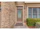 Close-up of a brick-lined front entrance, showcasing a well-maintained door and manicured greenery at 2479 Brynfield Cv, Suwanee, GA 30024