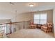 Cozy loft area with sitting chairs, carpet floors, and a view to the main level at 2479 Brynfield Cv, Suwanee, GA 30024