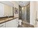 Bathroom featuring a glass-enclosed shower, granite countertop, and white cabinets at 270 17Th Nw St # 1113, Atlanta, GA 30363