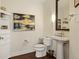 Traditional-style powder room with pedestal sink and beautiful art at 270 17Th Nw St # 1113, Atlanta, GA 30363